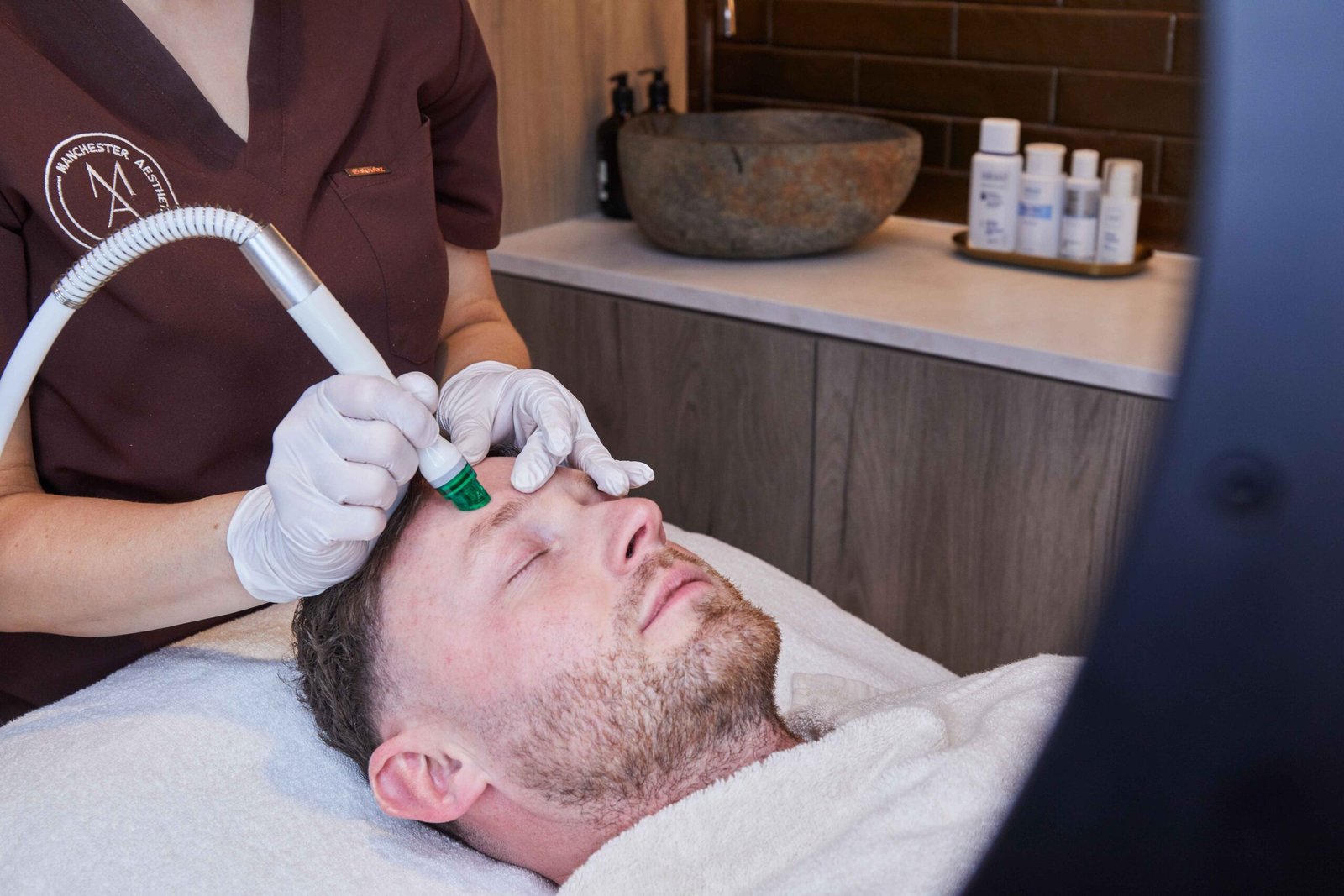 Hydro2 facial treatment being performed on a male client at a Manchester clinic