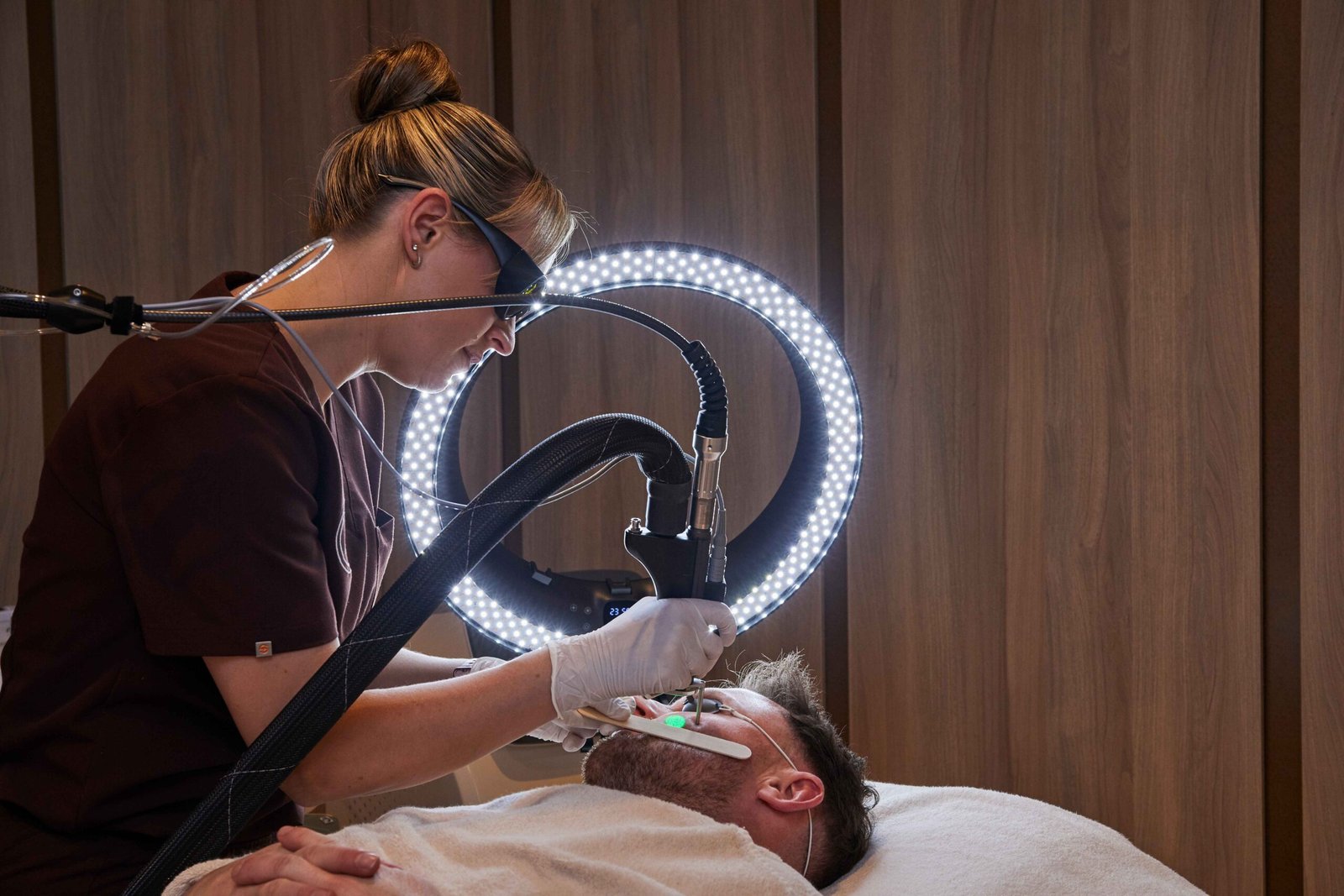 Laser hair removal treatment being performed on a male client in a Manchester clinic