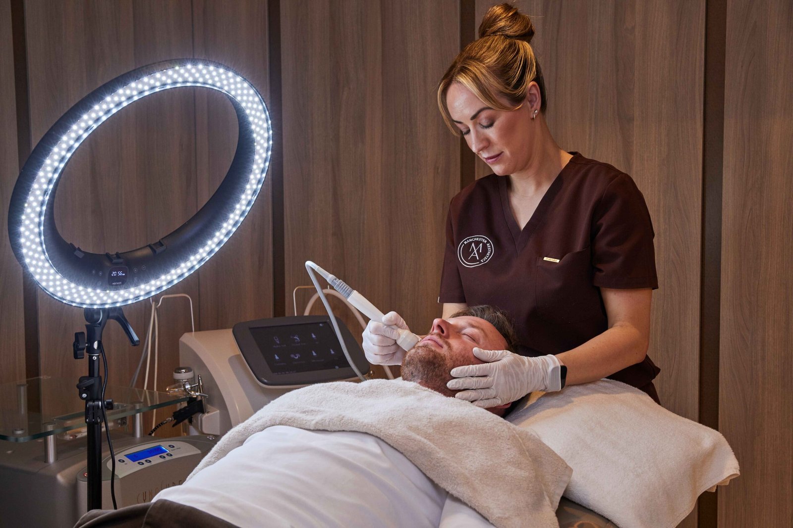 Radio frequency skin tightening facial being performed on a male client at a Manchester aesthetic clinic
