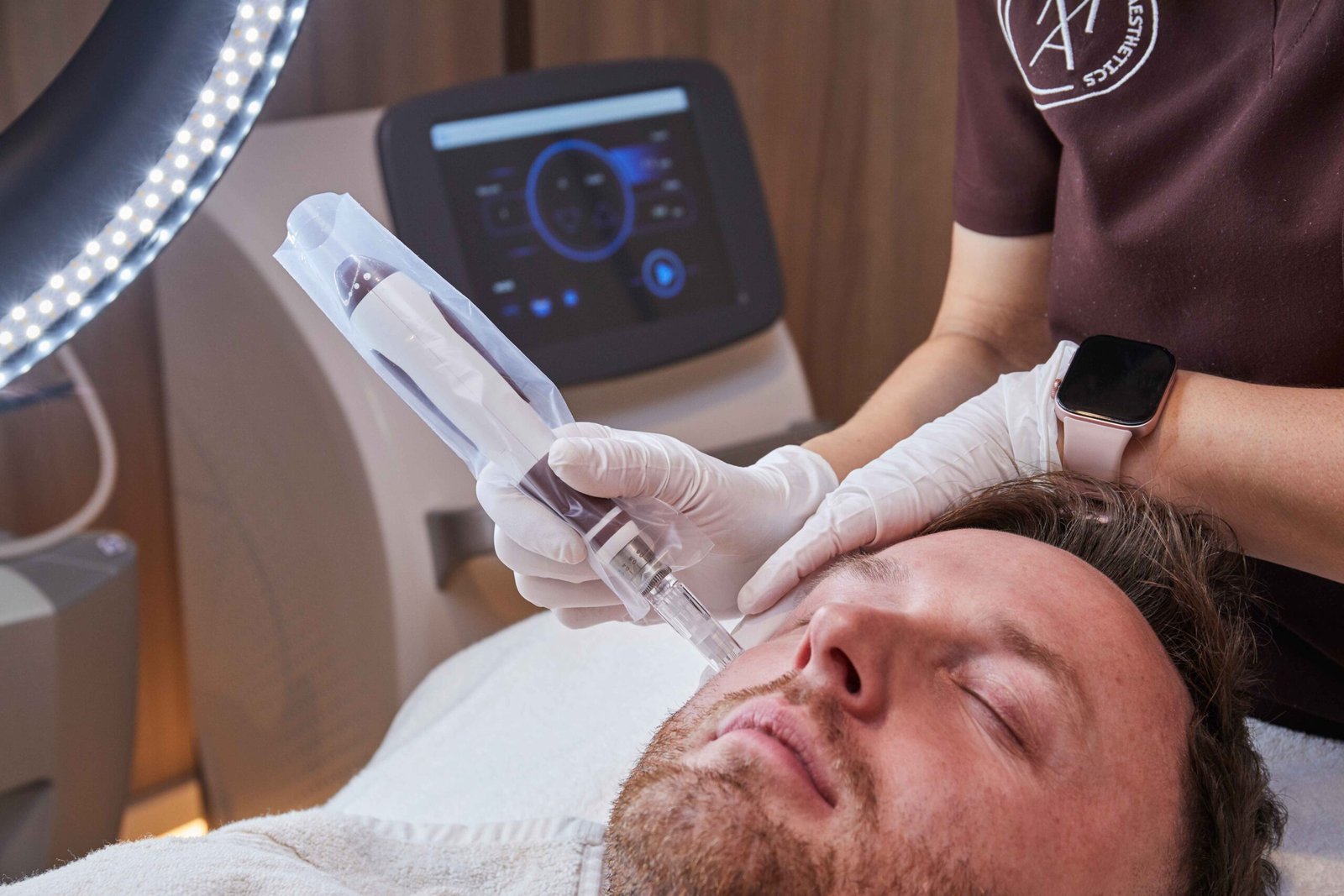 Microneedling facial treatment being performed on a male client at a Manchester aesthetic clinic