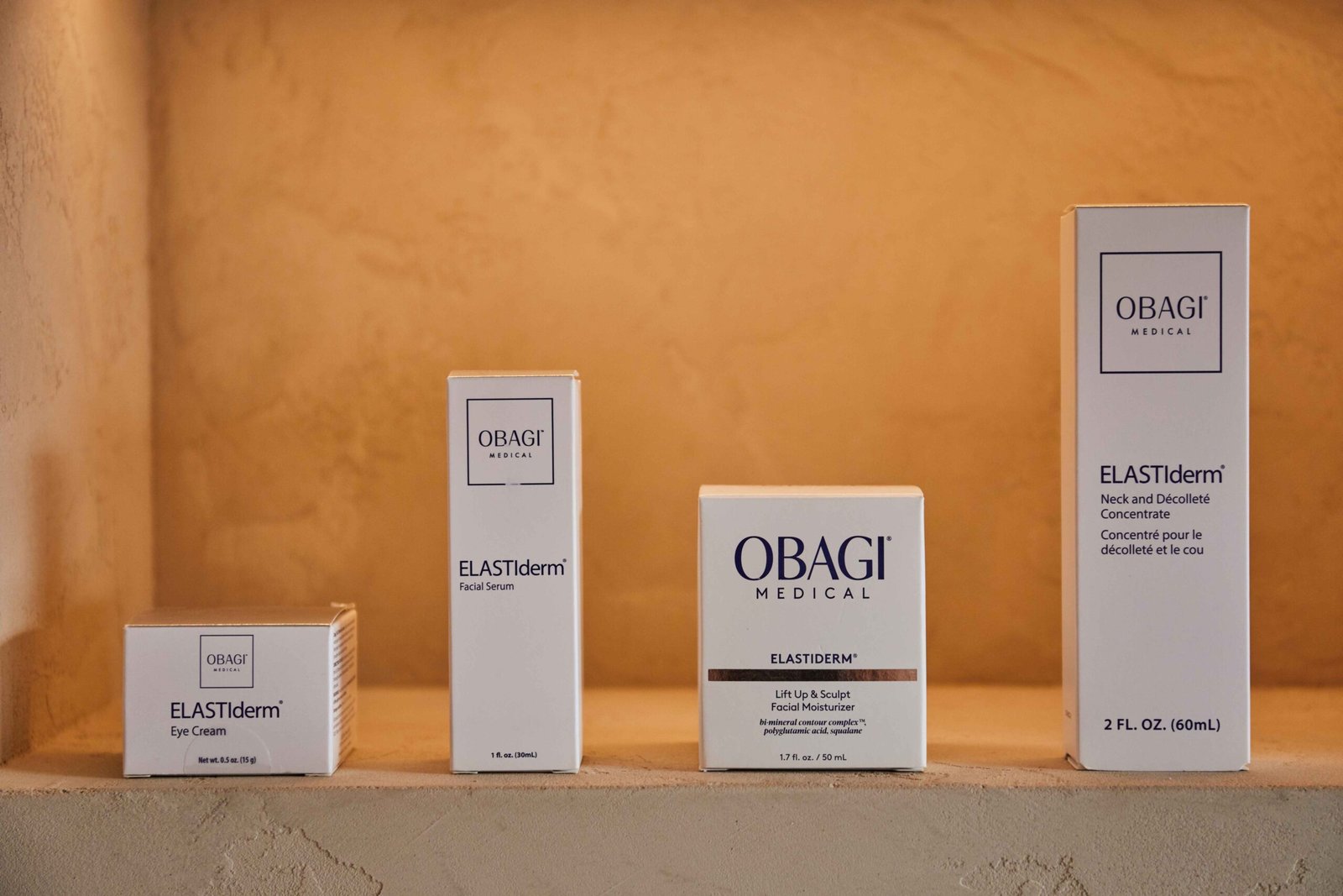 Full range of Obagi ELASTIderm anti-aging skincare products displayed on shelf showing eye cream lift serum and neck decollete treatment
