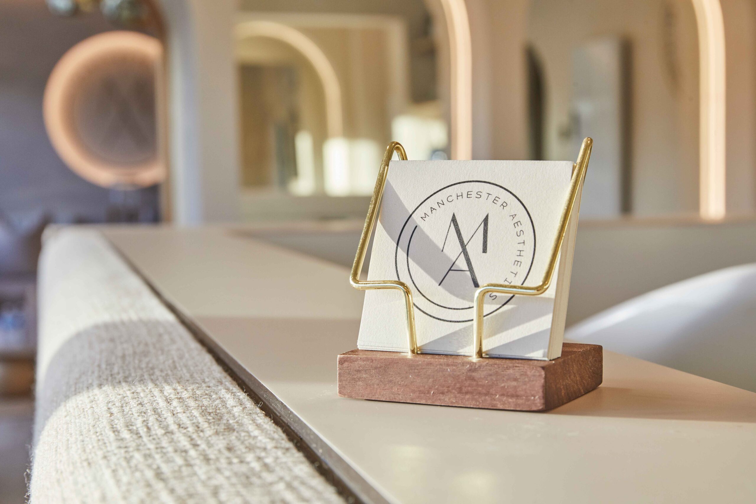 Manchester Aesthetics clinic branding at reception desk